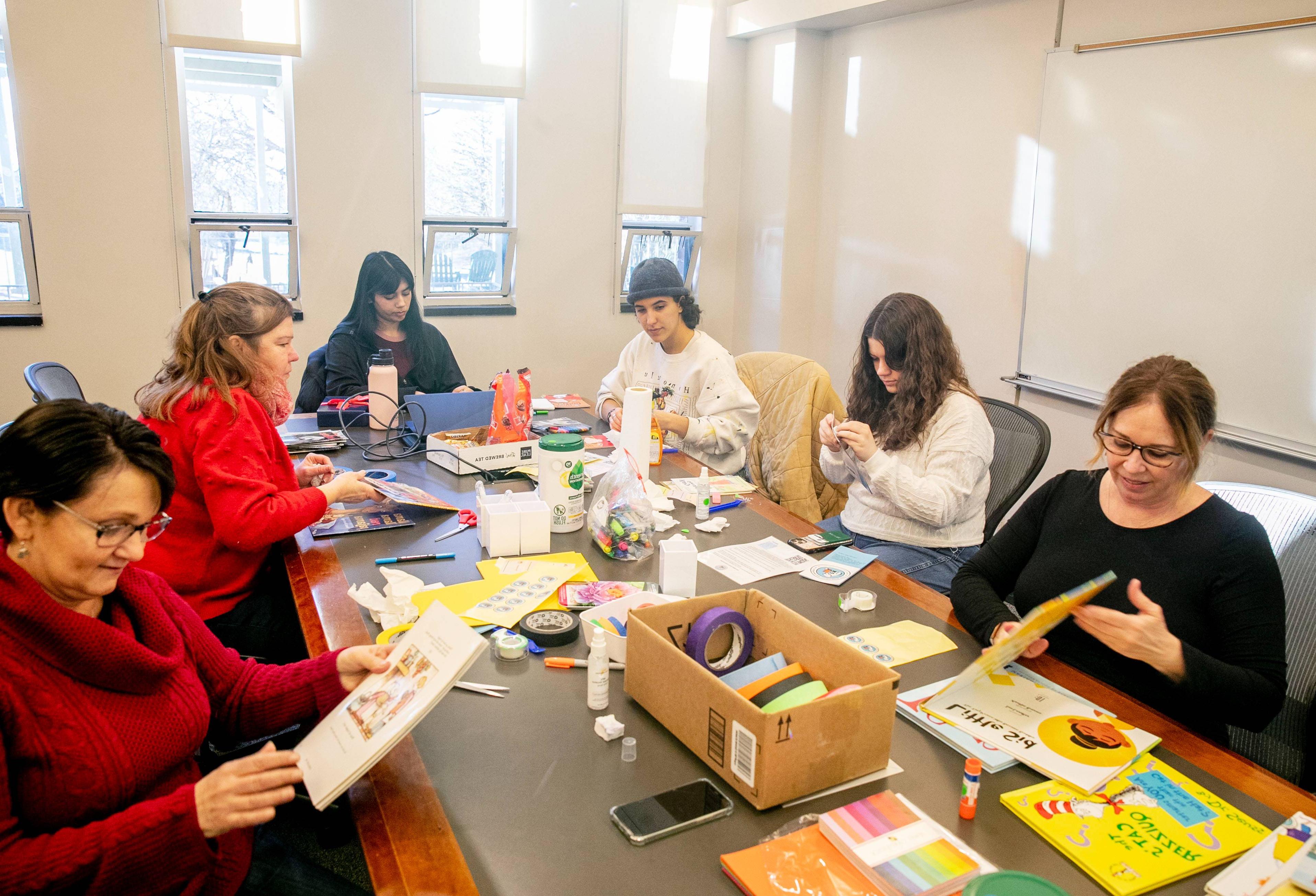 Students repairing children's books for volunteer service